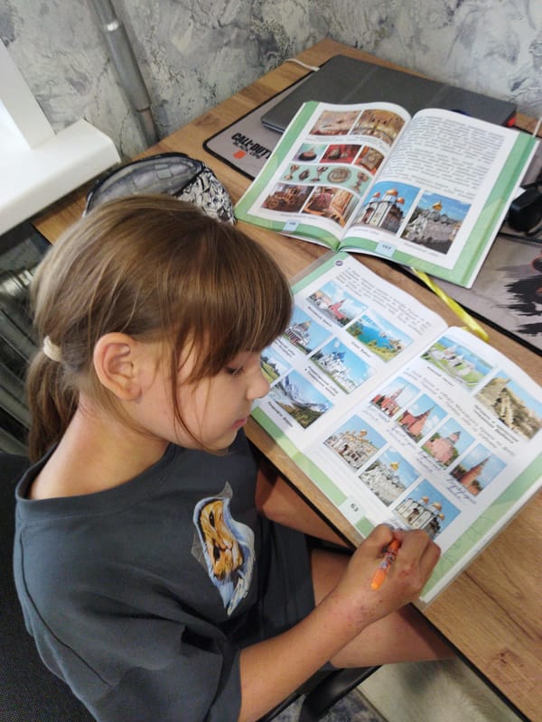 Young girl studies, plays with masks in Yaroslavl