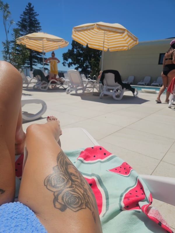 Sunny resort pool day, lounging and unwinding.