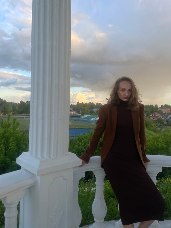 Woman photographed on balcony overlooking Sharkan, Russia