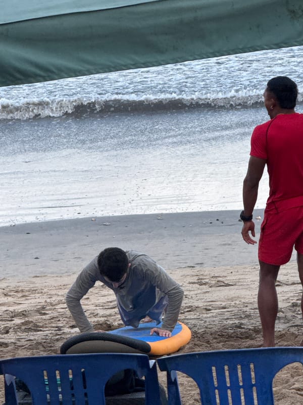 Surfboards and activity on a cloudy Kuta Beach morning