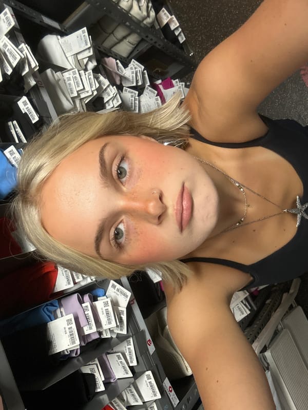 Woman takes selfies in Whistler retail store stockroom