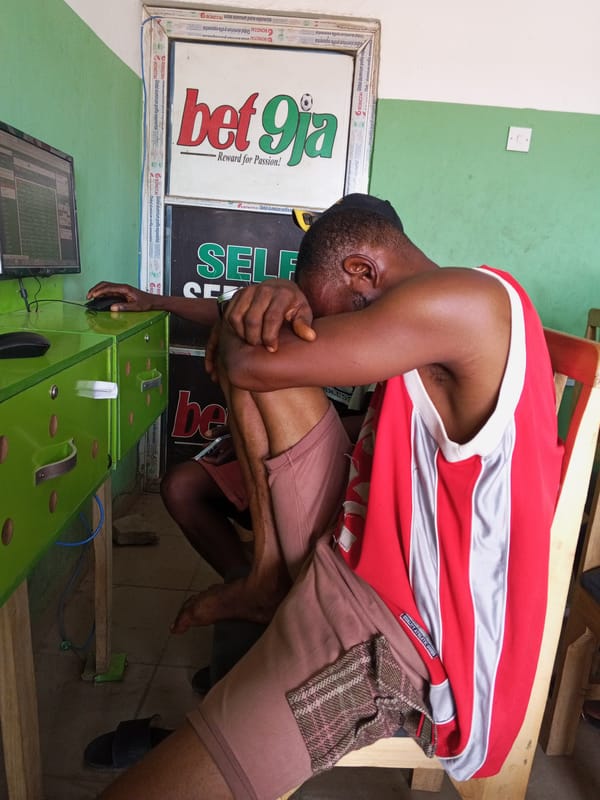 Men socialize at betting shop in Adankolo, Nigeria