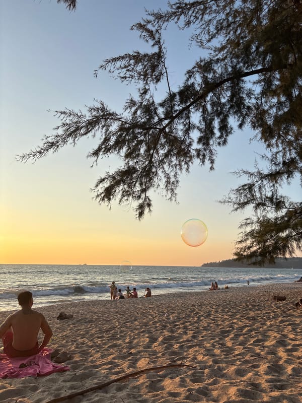 Person observed at sunset beach scene in Choeng Thale
