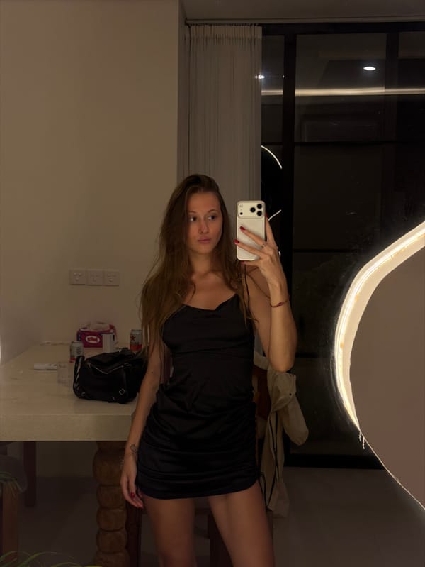 Woman takes mirror selfie in Indonesian hotel room