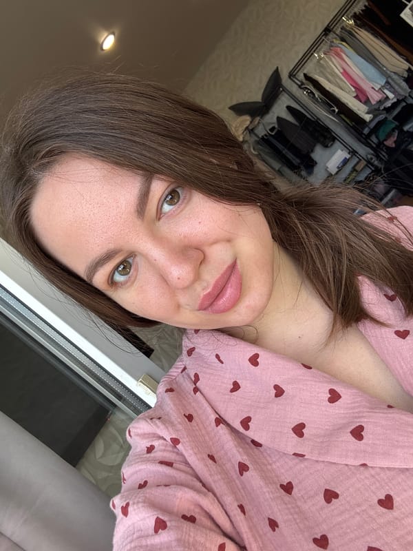 Woman takes morning selfies in pink heart pajamas