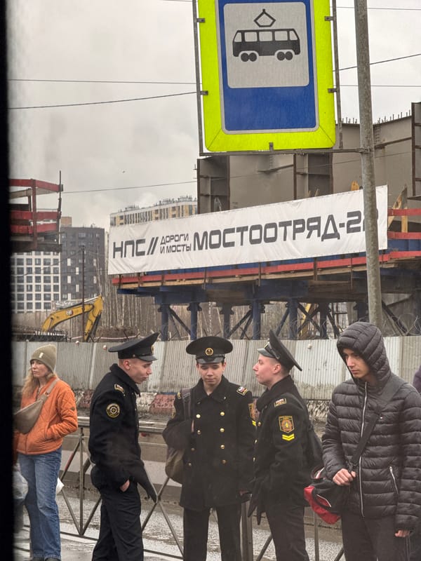 Uniformed officers, civilians gather on Saint Petersburg sidewalk
