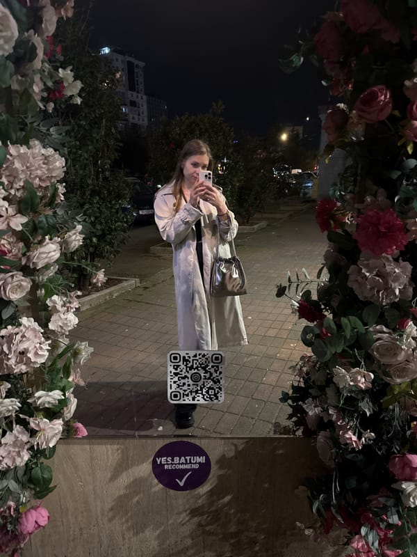 Woman takes nighttime selfie in downtown Batumi