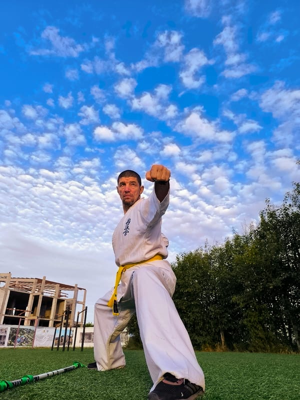 Yellow-belt karate practice on turf in Qarağandı