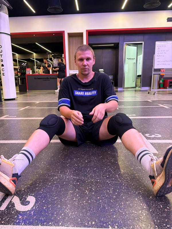 Inside a Thai gym, mid-session rest and studio signage