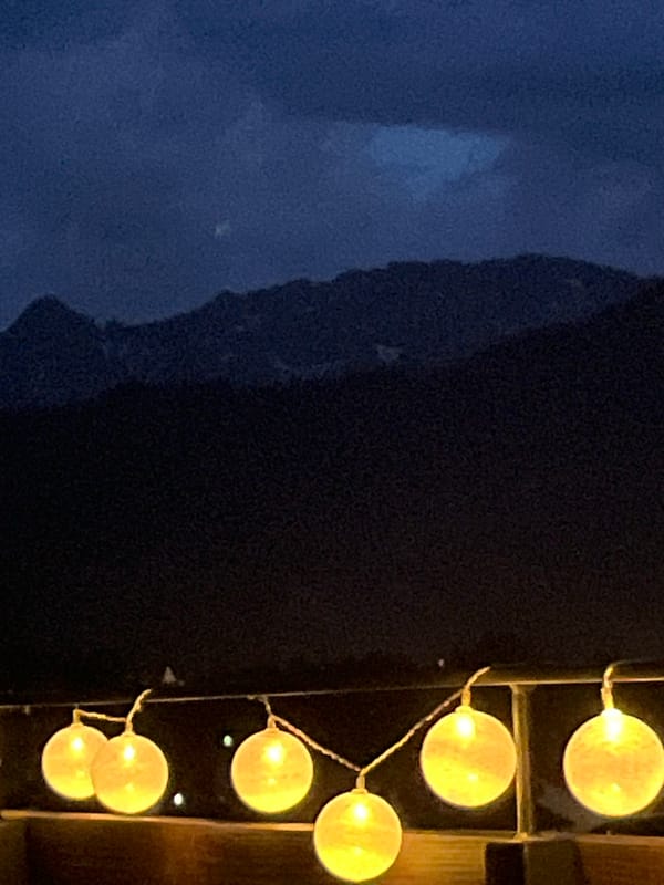 String lights and mountain silhouettes on a Garmisch evening terrace