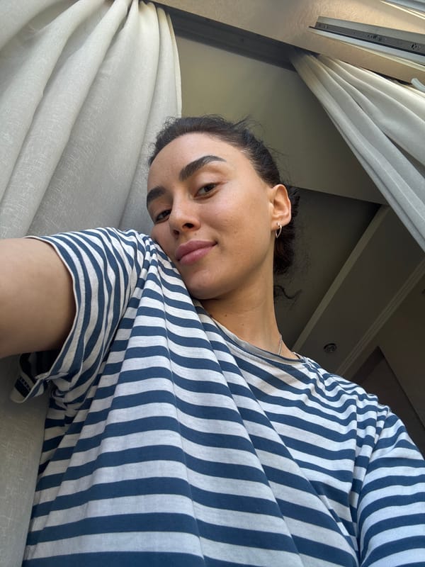 Woman poses for multiple photos indoors in Tbilisi
