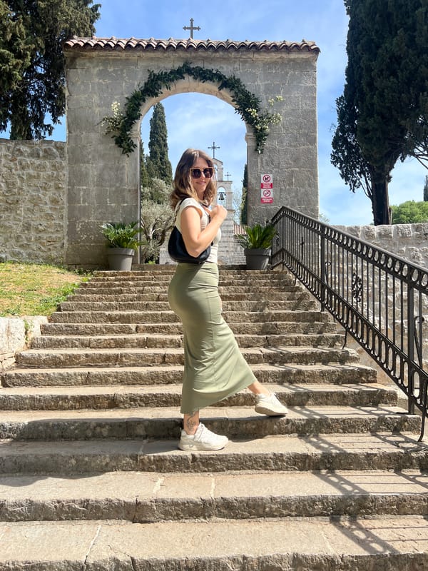 Woman in green dress spotted on stone steps in Podgorica