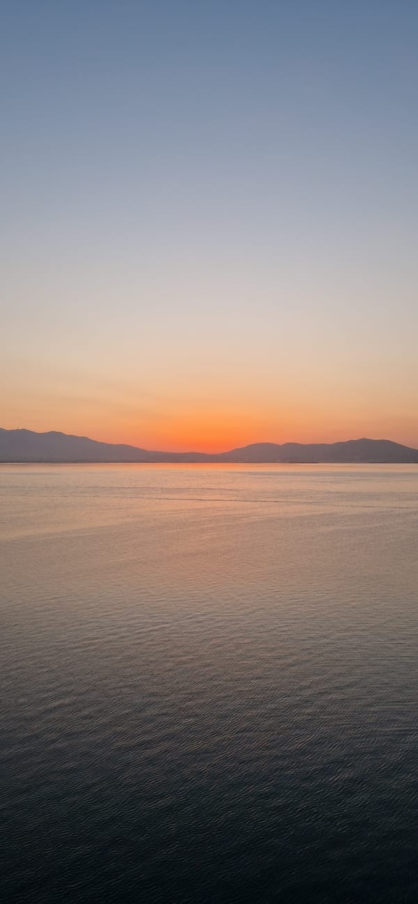 Sunset to twilight from a tanker deck off Salamina, Greece