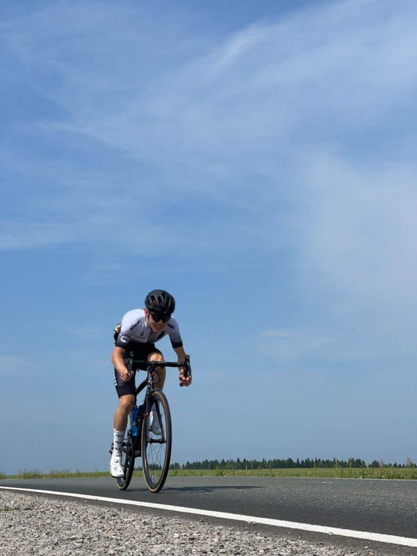 Organized road cycling race rolls through Perevoznoye with full support convoy