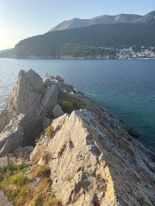 Weathered coastal stairs meet the Adriatic at Petrovac, Montenegro