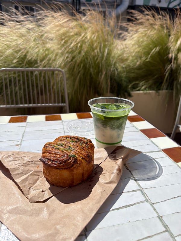 Sunny morning at a London café-bakery, green drink in hand