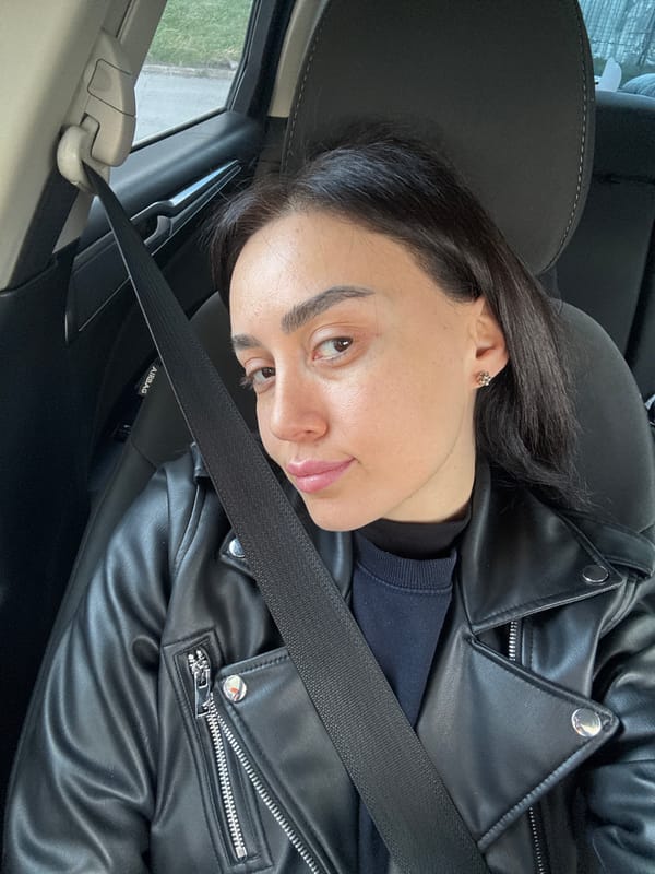 Woman in black leather jacket drives through Tbilisi