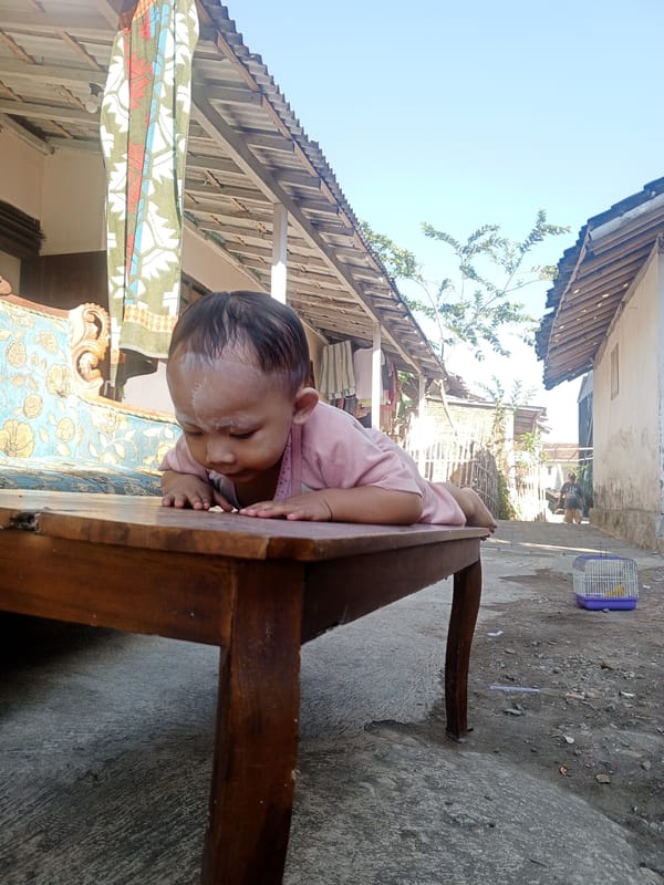 Child with white powder on face spotted outdoors in Jember