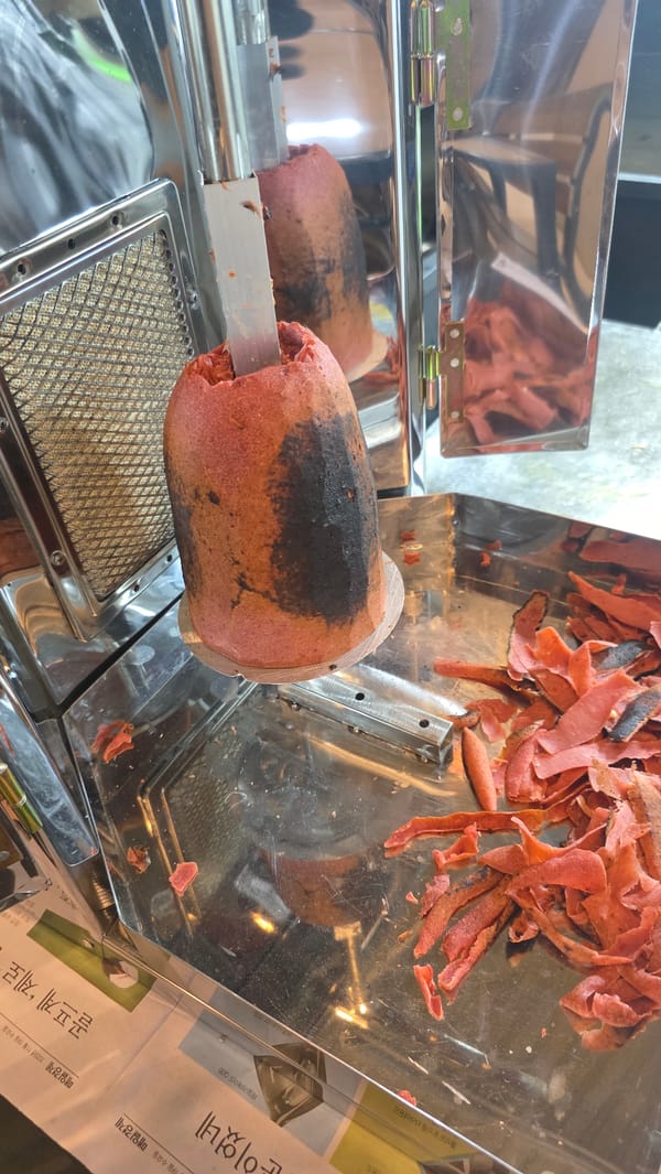 Street food vendor serves rolled wraps in Palohigeuh