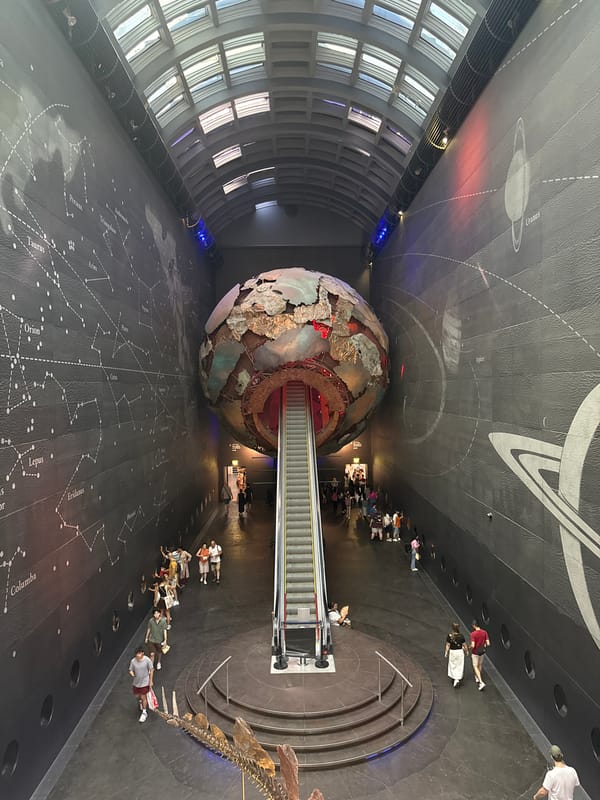 Giant suspended planet sphere dominates a London science center interior
