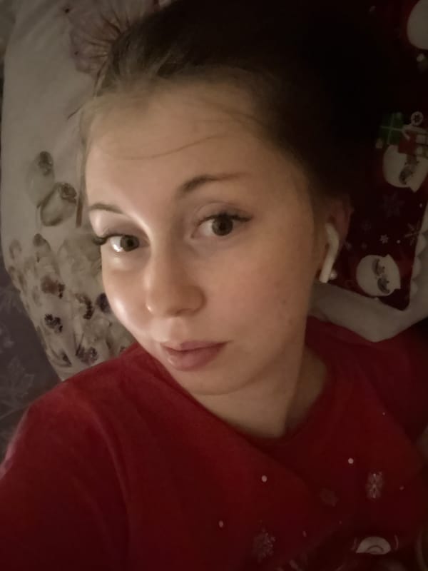 Person takes multiple indoor selfies in red Christmas shirt