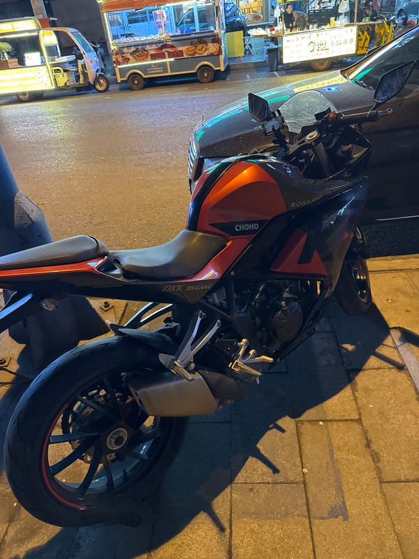 Motorcycle parked near food vendors in Zhongtun, China