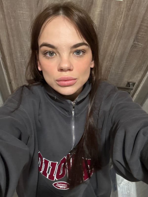 Woman Takes Selfies in Gray Sweatshirt in Anapa
