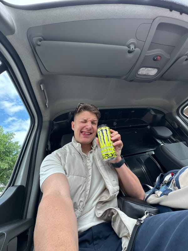 Taxi driver poses with energy drink, dog in Bulgaria
