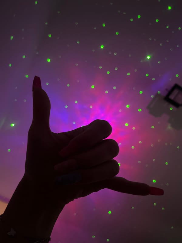 Hand gestures captured against colorful lights in Plovdiv Bulgaria