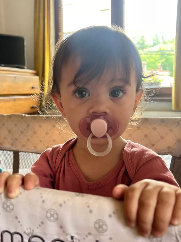 Baby with pacifier observed near window in Elena, Bulgaria