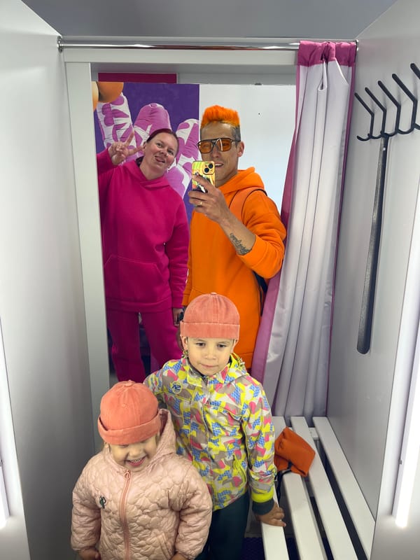 Orange-clad person shops, poses with child in Chaikovsky