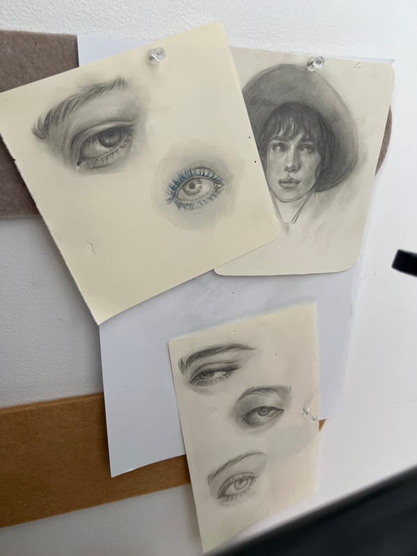 Art studio documentation with sketches, paintings, and creative materials