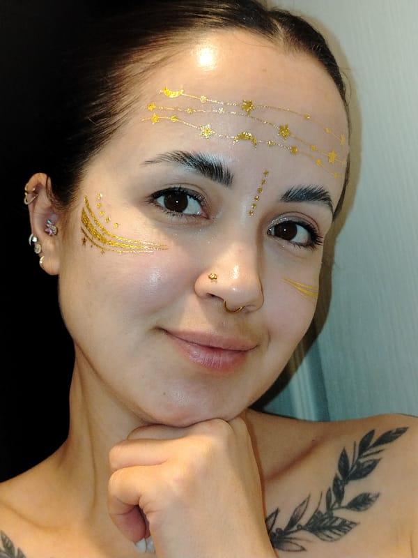 Woman with gold face art, playful dog captured indoors