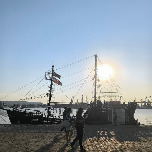 Sunset at Varna Port: ships, cranes, cats, and fairground rides