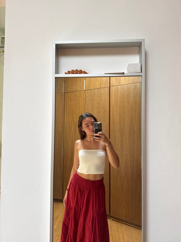 Woman takes mirror selfie in bedroom in Mexico