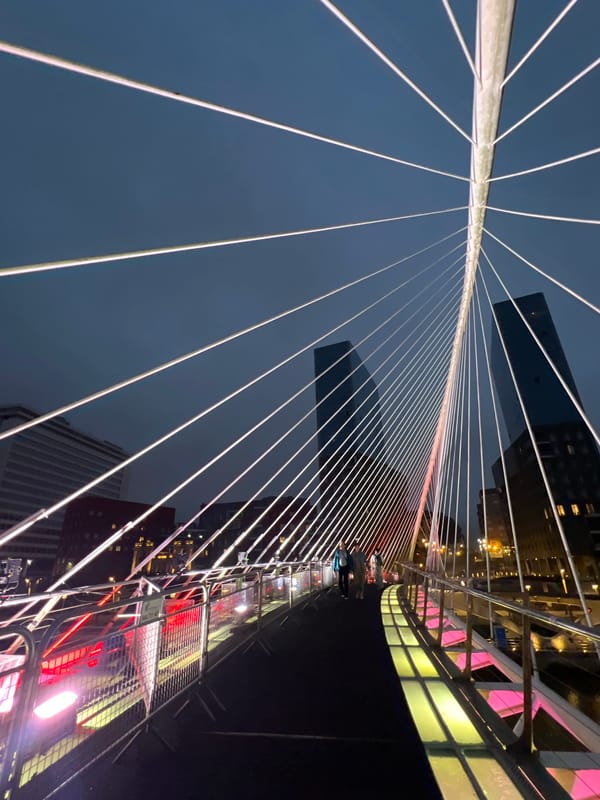Bilbao's Zubizuri Bridge illuminated at dusk, multiple angles