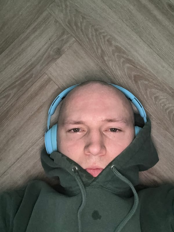 Person in headphones lies on wooden floor in Krasnoyarsk