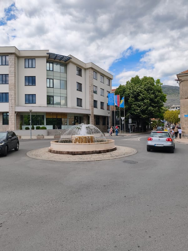 Trebinje street scenes captured including roundabout fountain and park