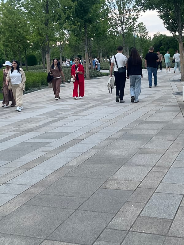 Afternoon park gathering documented around globe statue in Krasnodar