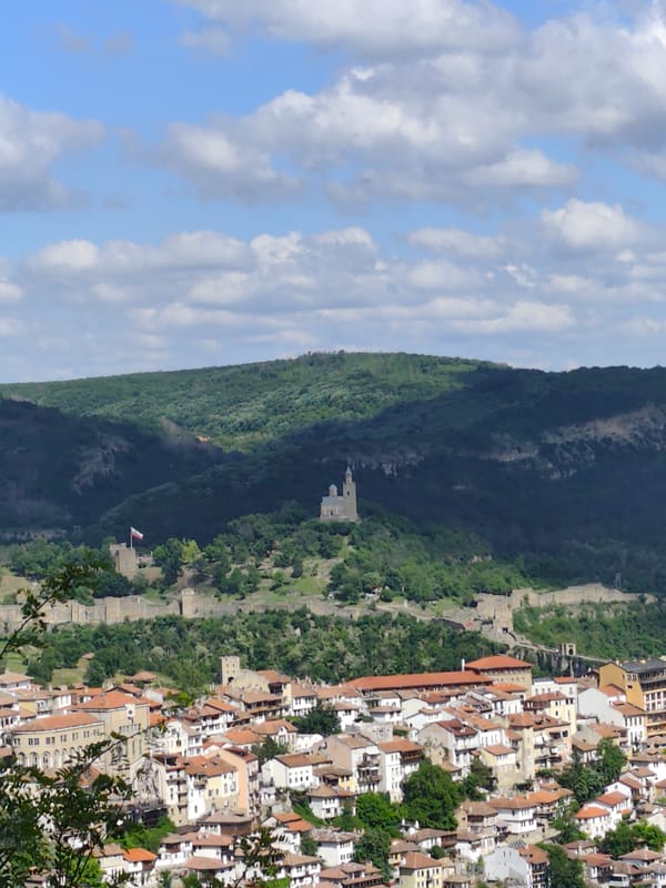 Hillside city with red roofs documented from multiple vantage points