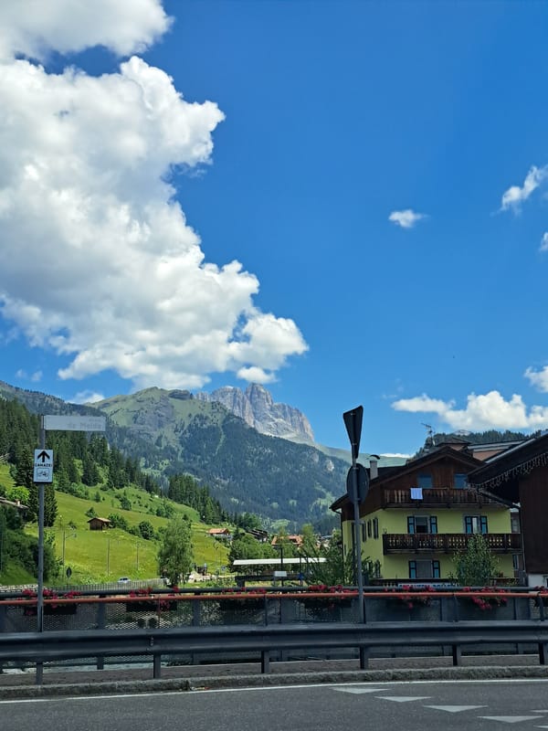 Driving through a classic alpine village on a sunny morning