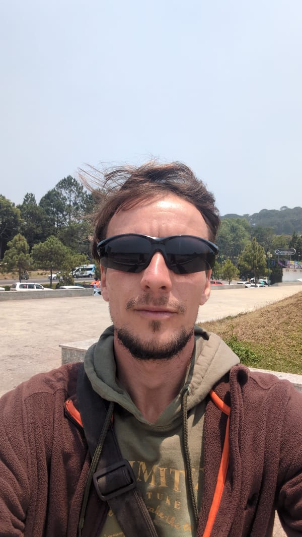 Man photographed at landscaped lakeside plaza in Da Lat