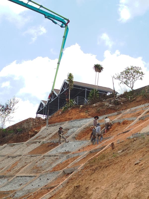 Construction crew works on terraced slope in Đa Thọ