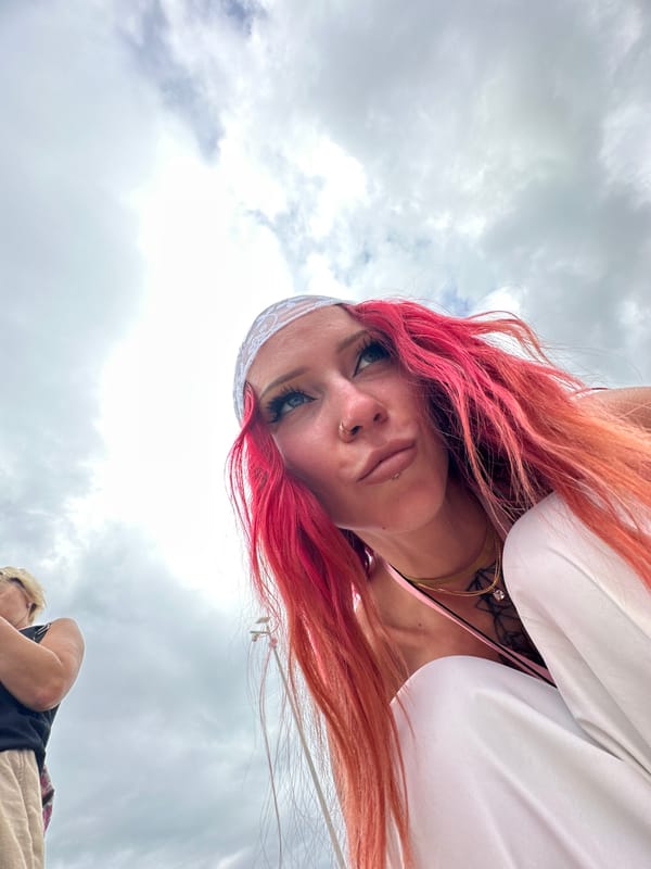 Pink-haired woman photographed in low-angle shots across Indonesian locations