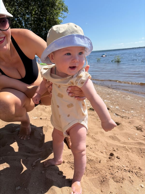 Baby's first beach day on a Russian summer shore