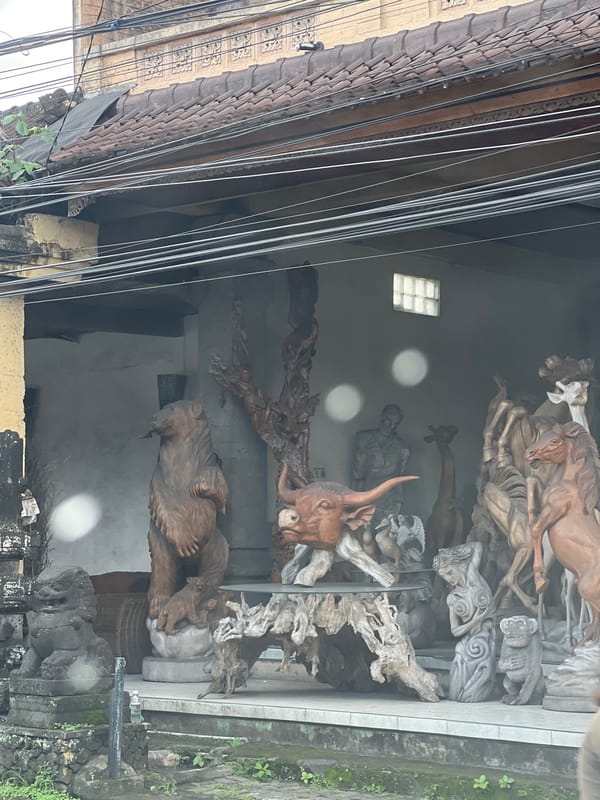 Motorcycle ride through Ubud's wooden sculpture shops captured
