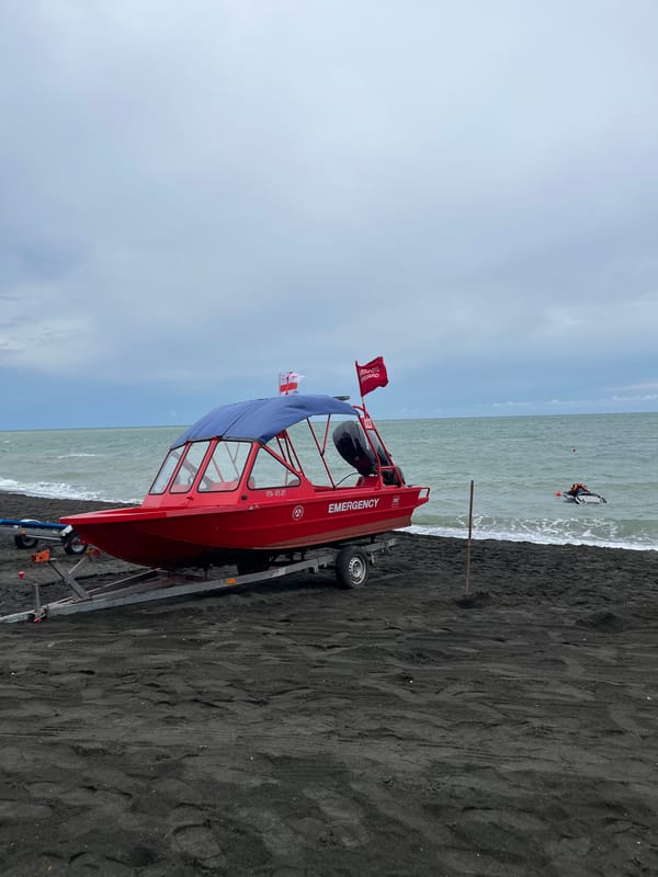 Busy morning on Ureki's black sand beach