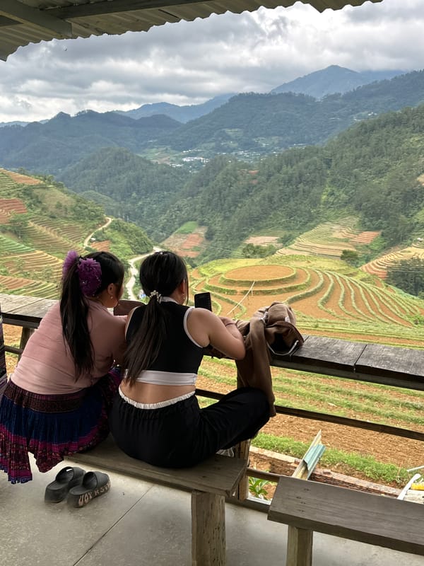 Two women observe terraced fields in Pung Luong Vietnam