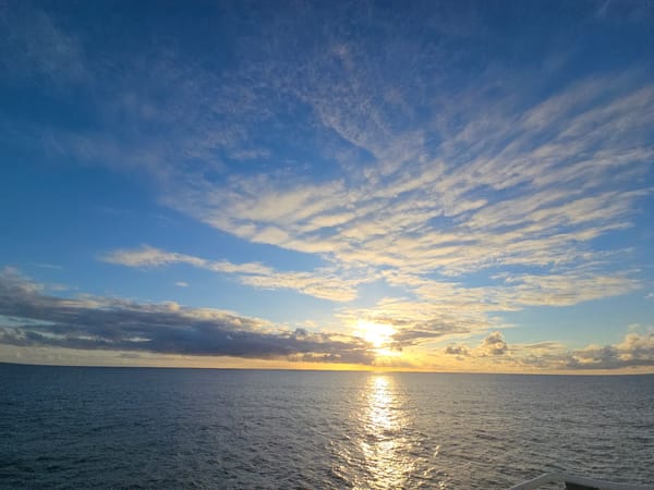 Sunset seascape documented with distant maritime structure visible