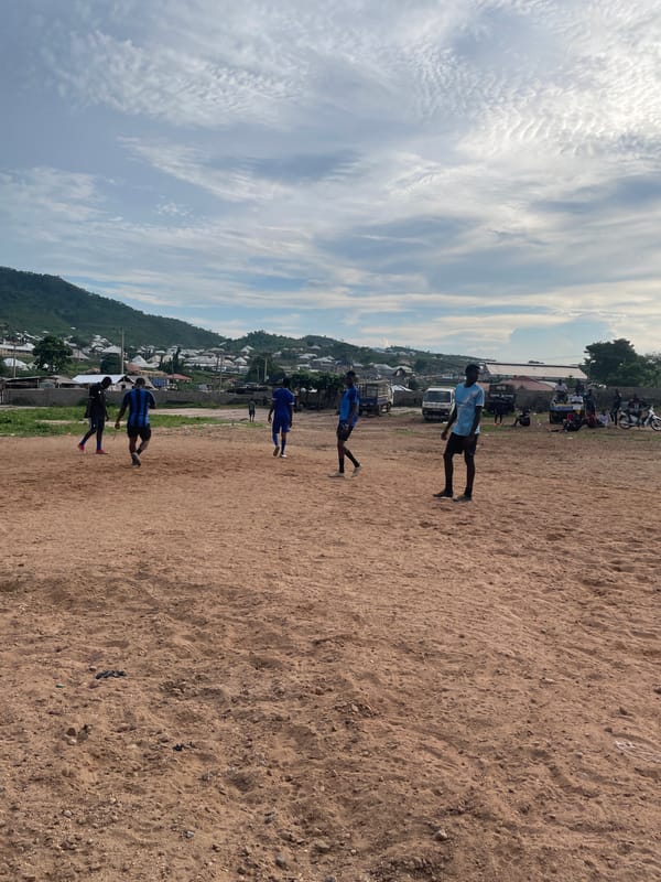 Football session on a dusty pitch in Lokoja, Nigeria